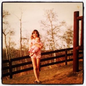My sister Lisa holding me, at home on the ranch, 1982 or so.